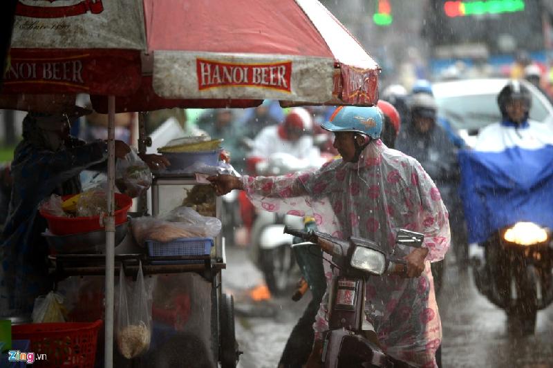 Buổi sáng trời mưa, nhiều người dân chưa kịp ăn sáng tranh thủ dọc đường mua đồ ăn lót dạ.