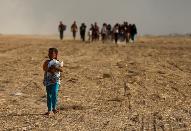 Một em bé trở về nhà sau khi ngôi làng ở phía nam Mosul được giải phóng khỏi sự chiếm đóng của lực lượng Nhà nước Hồi giáo tự xưng (IS). Quân đội Iraq và các chiến binh người Kurd tuần qua đã bắt đầu chiến dịch tấn công chiếm lại Mosul, "thủ phủ" của IS. Ảnh: Reuters.
