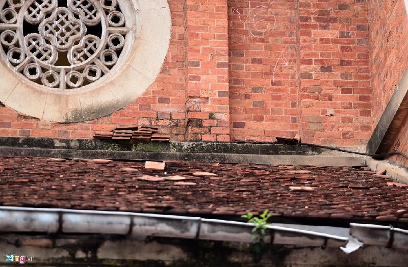 Nhiều viên ngói vảy cá ở mái thấp hai bên hiên nhà thờ cũng bị tốc nằm rải rác. Một số viên được xếp chồng trên bờ mái.