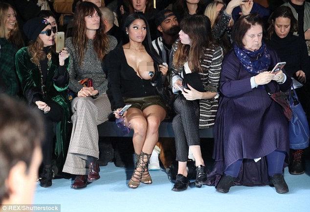 Hôm 4/3, Nicki Minaj tham dự show thời trang của nhà mốt Haider Ackermann tại Paris Fashion Week thu đông 2017. Trong khi các vị khách hàng ghế đầu đều ăn mặc kín đáo, nữ rapper chọn chiếc áo lệch vai, để hở trọn một bên ngực. 