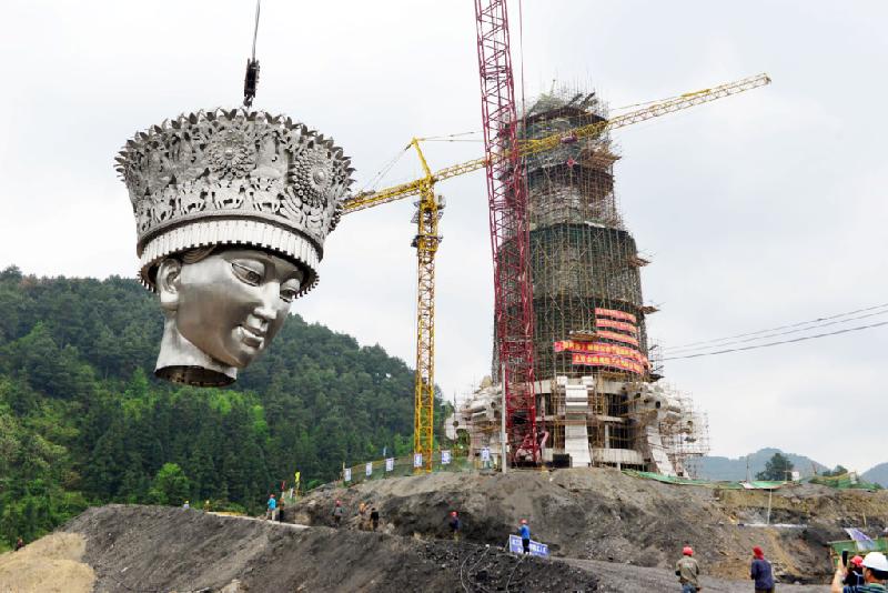 Các công nhân tiến hành lắp ráp phần đầu tượng nữ thần dân tộc Miêu tại huyện Kiếm Hà, tỉnh Quý Châu, miền Nam Trung Quốc hồi giữa tháng 4. Đất nước đông dân nhất thế giới là nơi có nhiều bức tượng khổng lồ ở khắp các tỉnh thành.