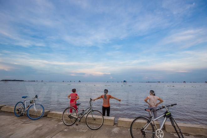Chiều chiều, nhiều người dân vùng này vẫn thường đạp xe dọc bờ biển để thể dục vừa để hít hà cái vị mặn mòi của biển. (Ảnh: Minh Sơn/Vietnam+)